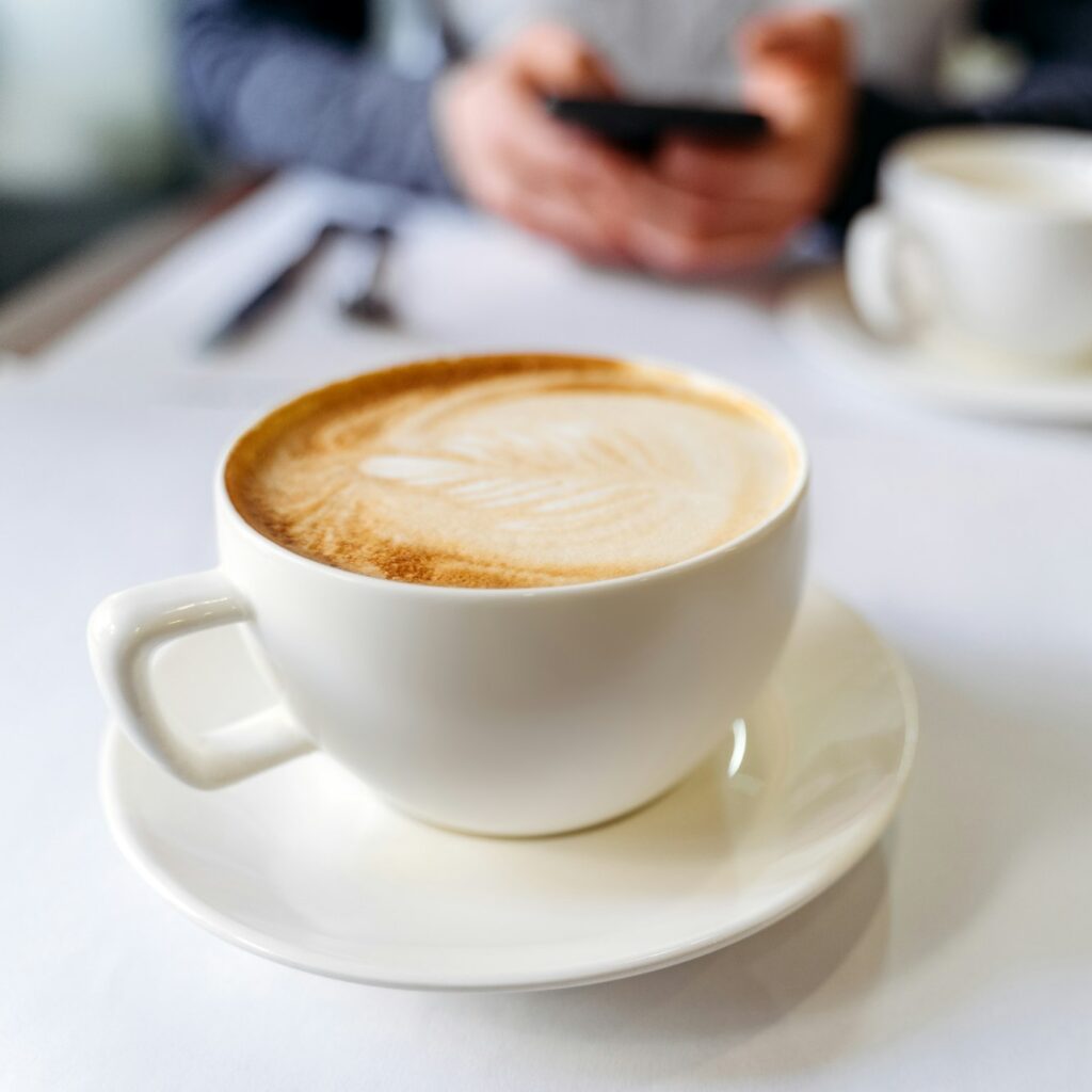 Cup with coffee on the table in a coffee shop.